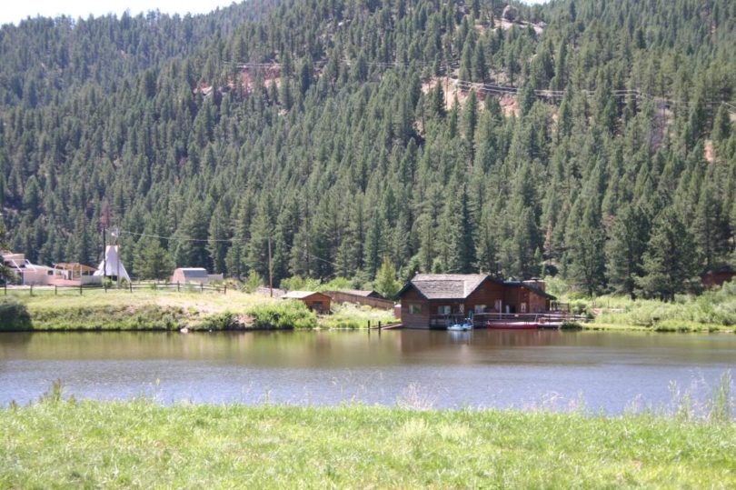 view of home behind lake