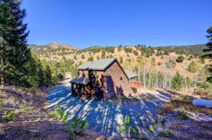 house exterior in front of tree line