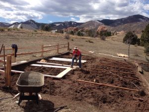 Helene building raised boxes in garden