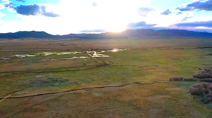 view of creek with sunset